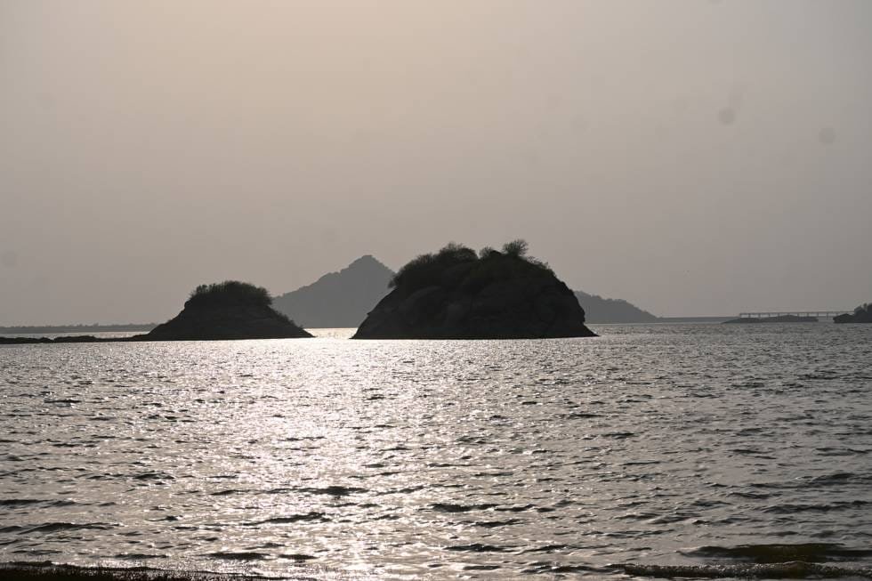 Rocky islands silhouetted on the Jawai dam at sunset, western Rajasthan