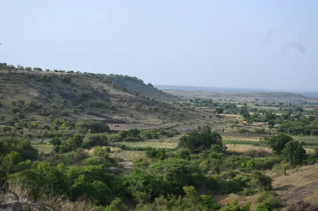 Evening view from a hillside near Bhigwan over scrub, fields and low hills