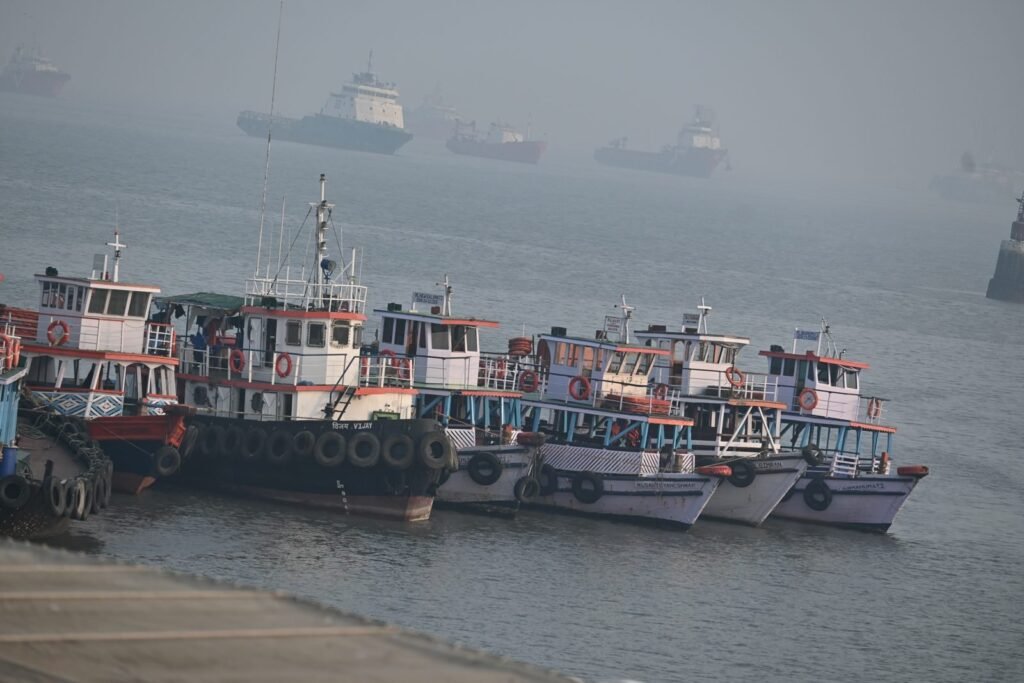 Boats lined up in Mumbai harbour on a hazy morning