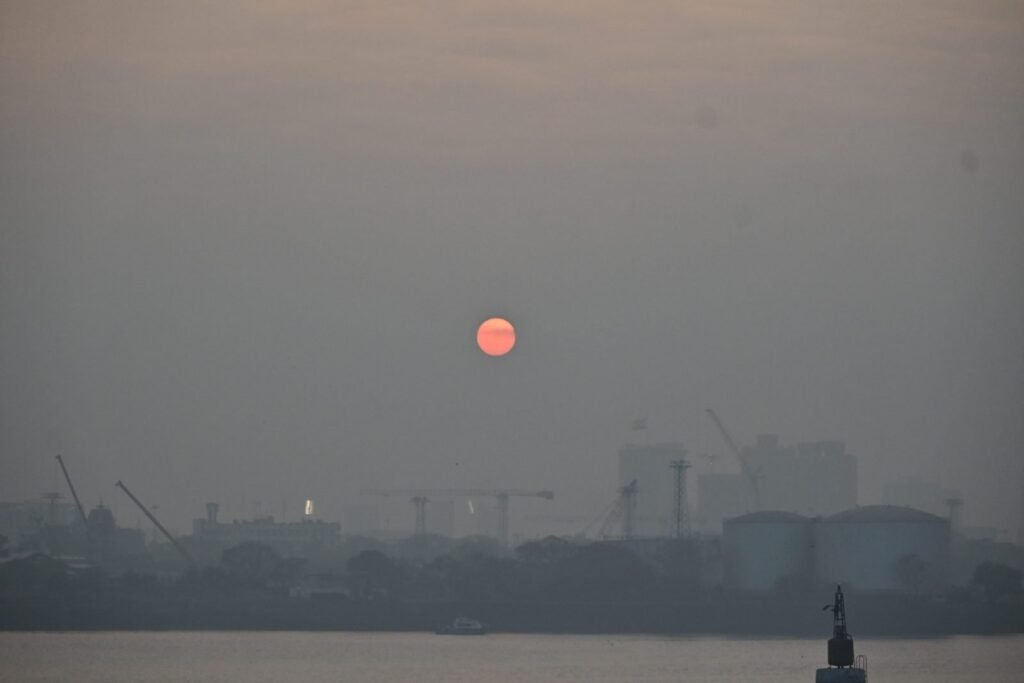 The sun rising through the haze over Mumbai harbour